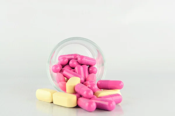 Medicine tablet and capsule in glass — Stock Photo, Image