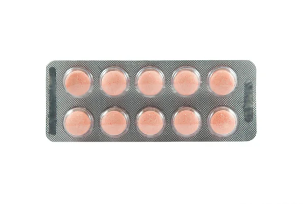 Orange medicine tablet in transparent blister pack — Stock Photo, Image