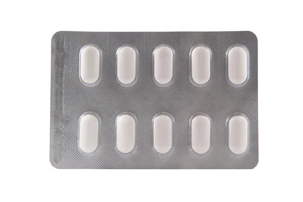 Long white tablet in transparent blister pack — Stock Photo, Image
