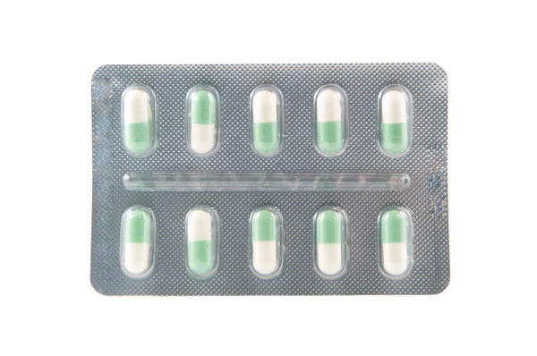 Closed up green and white hard capsule in transparent blister pa — Stock Photo, Image