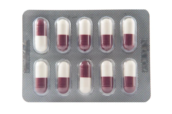 White and brown hard capsule in transparent blister pack — Stock Photo, Image