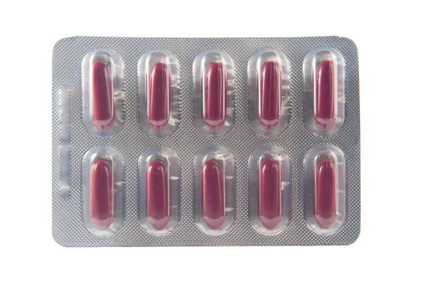 Envase blíster en cápsula de forma larga y roja — Foto de Stock