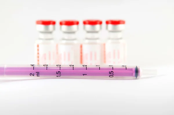 Purple disposable syringe and injection vials — Stock Photo, Image