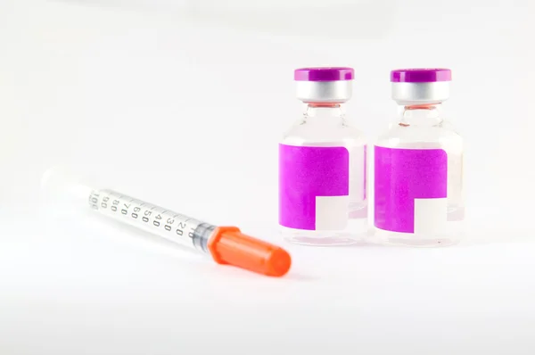 Disposable syringe and purple label injection vial — Stock Photo, Image