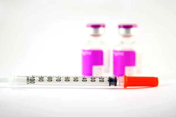 Disposable syringe and purple label injection vial — Stock Photo, Image