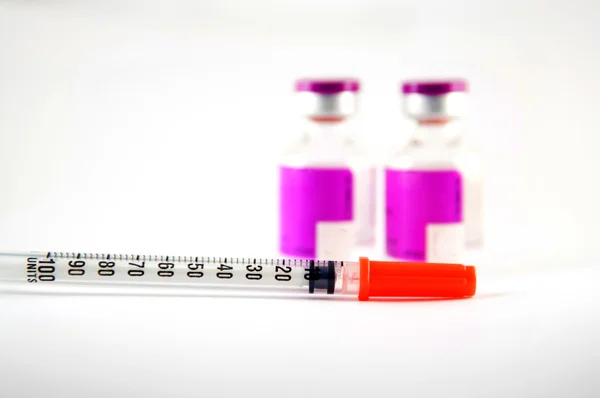 Disposable syringe and purple label injection vial — Stock Photo, Image