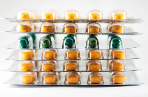 Stack green capsule and yellow tablet in blister pack — Stock Photo, Image