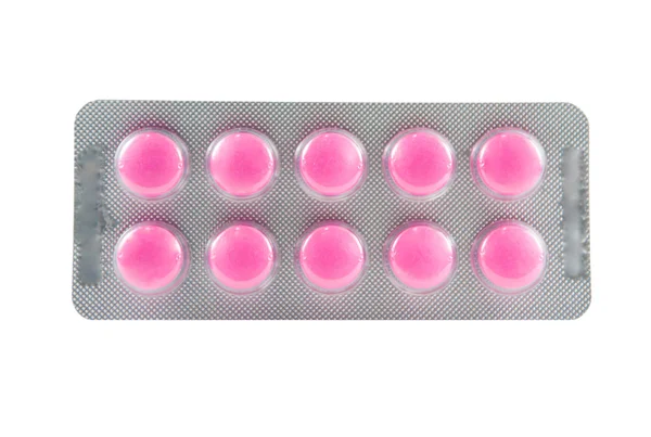 Pink tablet in packaging on white — Stock Photo, Image