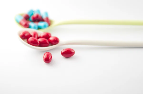 Spoon with medicine capsule — Stock Photo, Image