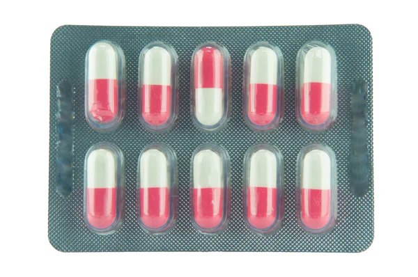 Embalagem blister isolada de cápsula rosa e branca — Fotografia de Stock
