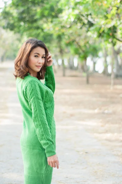 Green suit Asian woman in garden — Stock Photo, Image