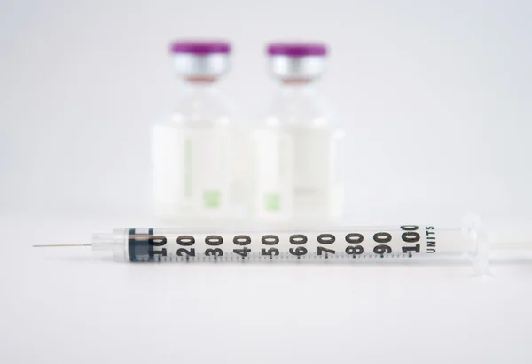 Disposable syringe on injection vials — Stock Photo, Image