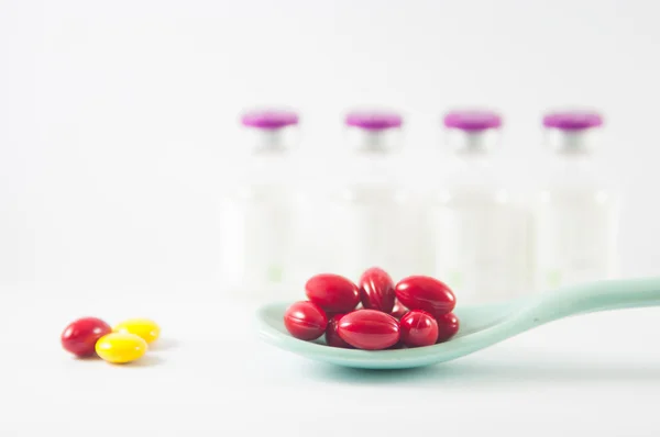 Yellow coating tablet in spoon — Stock Photo, Image