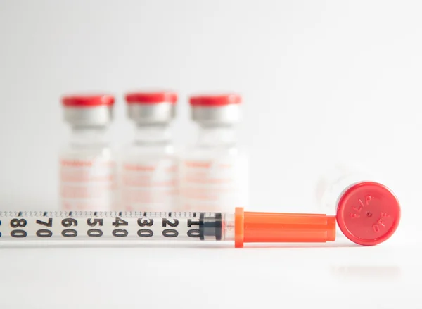 Disposable syringe on injection vials — Stock Photo, Image