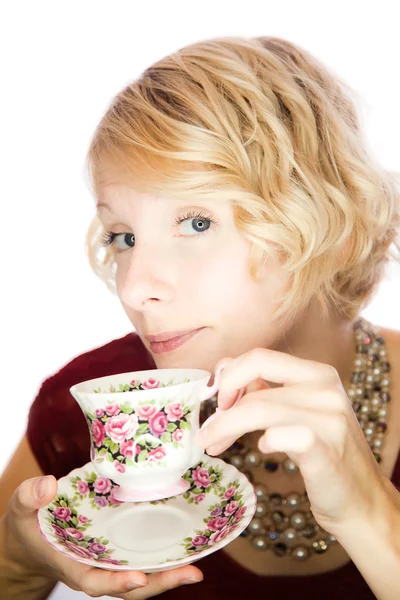 Portrait of a beautiful girl which drinks tea — Stock fotografie