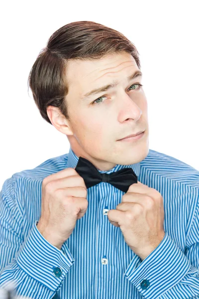 Handsome gentleman adjusting his bow tie — Stock Photo, Image