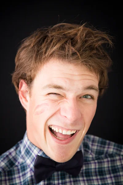 A fun young man with a trace of lipstick on his cheek — Stock Photo, Image