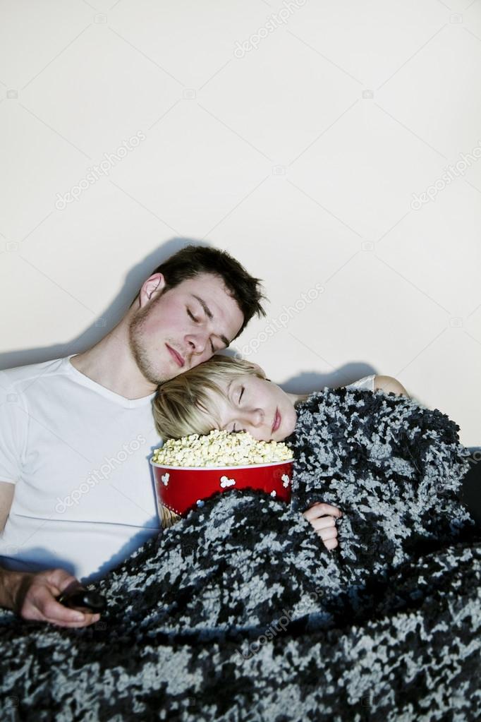 Young couple watching television.