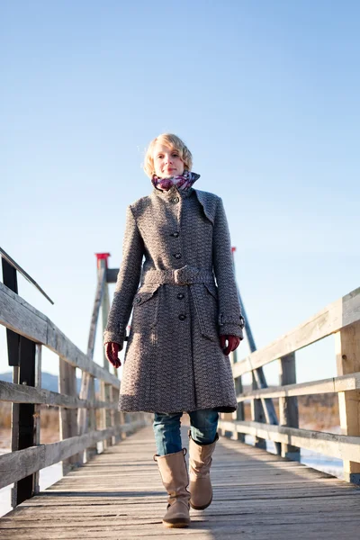 Girl on the bridge in the field — Stock Photo, Image