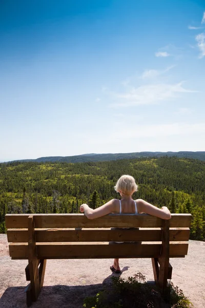 Girl sitting on a bench — Stock Photo, Image