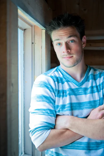 Young man at the window — Stock Photo, Image