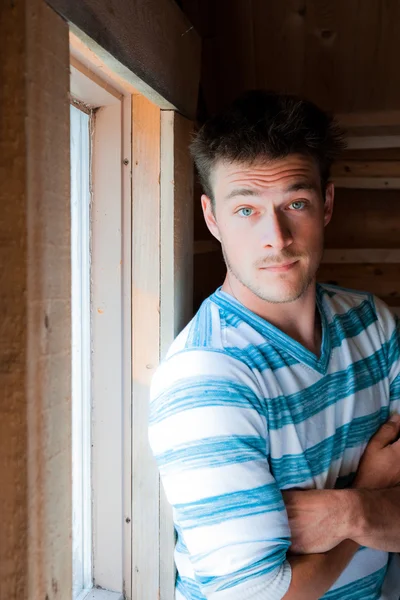 Young man at the window — Stock Photo, Image