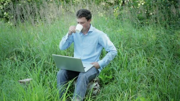 Empresario trabajando al aire libre con una taza de café — Vídeos de Stock