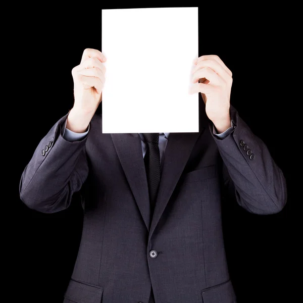 Businessman holding a sheet of paper in front of his face — Stock Photo, Image