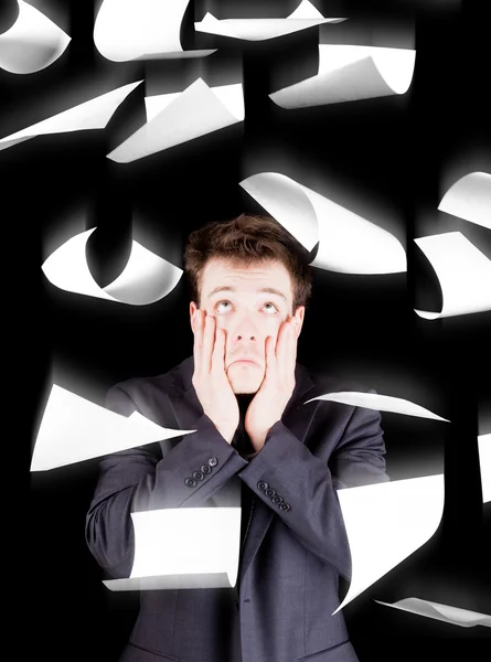 Despaired businessman with paperwork falling everywhere — Stock Photo, Image