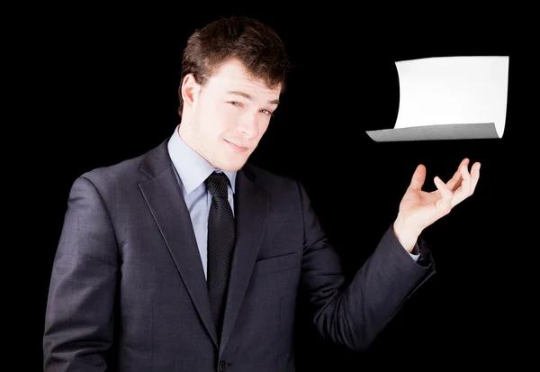 Empresário apresentando uma folha de papel em branco com espaço para texto — Fotografia de Stock
