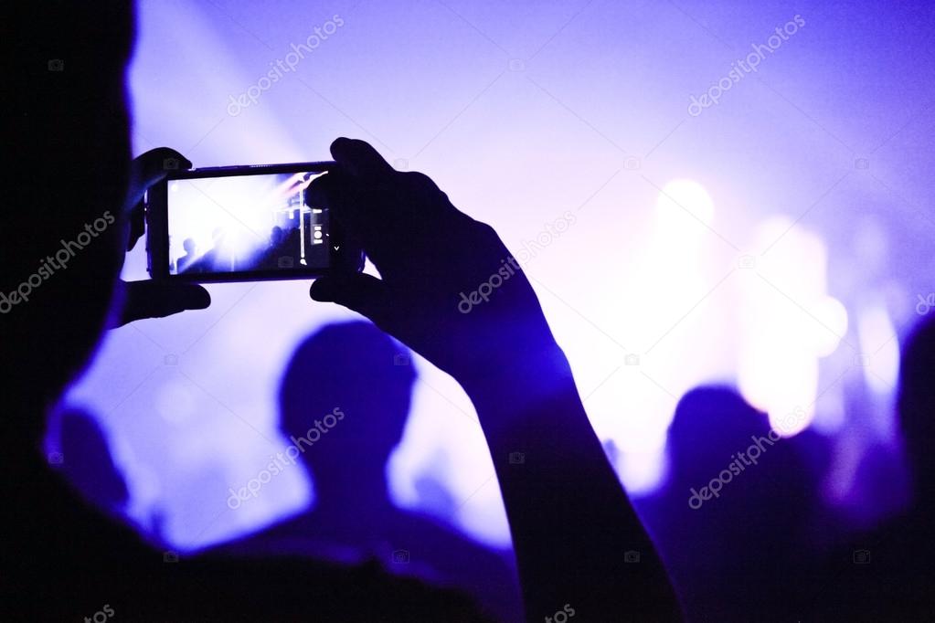 Someone talking a picture during a concert