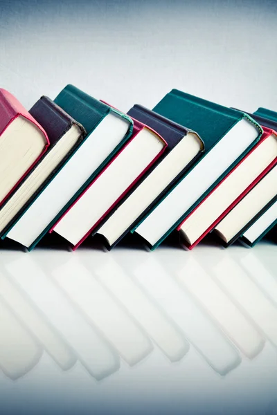 Red, black and green books in a row — Stock Photo, Image