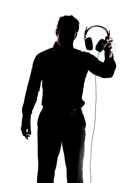 Maschio in silhouette mostrando cuffie — Foto Stock