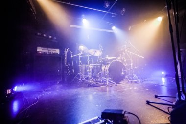 Drumkit on empty stage waiting for musicians clipart