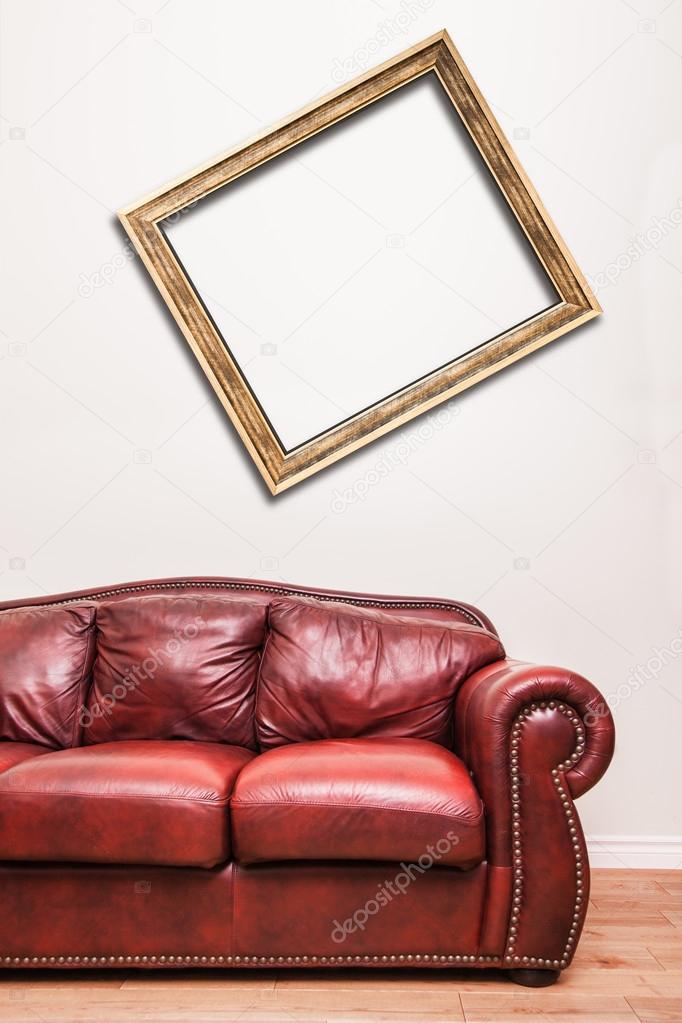 Luxurious Red Leather Couch in front of a blank crooked frame to ad your text, logo, images, etc.