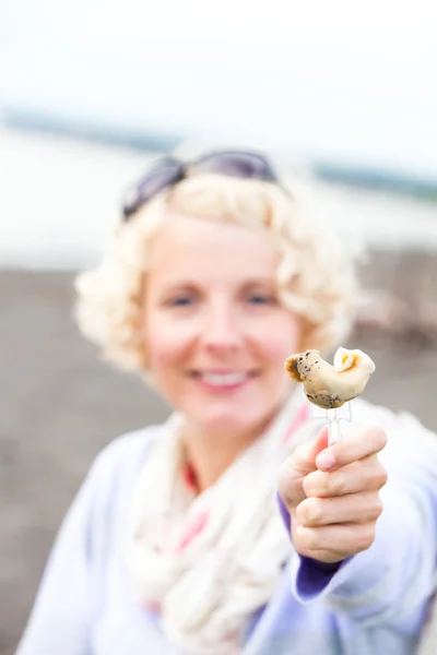 Молодая женщина ест улитку (бурго на французском языке) ) — стоковое фото