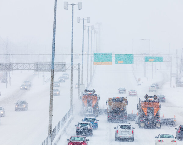 Tree Lined-up Snowplows Clearing the Highway
