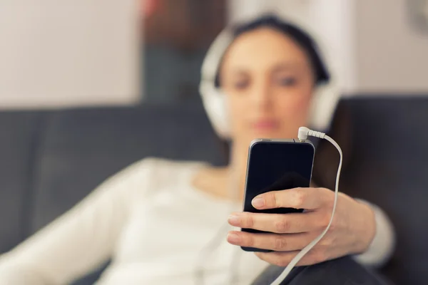 Entspannte Frau hört zu Hause im Wohnzimmer Musik — Stockfoto