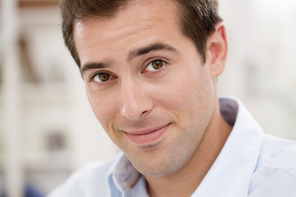 Interior portrait of looking relaxed happy male