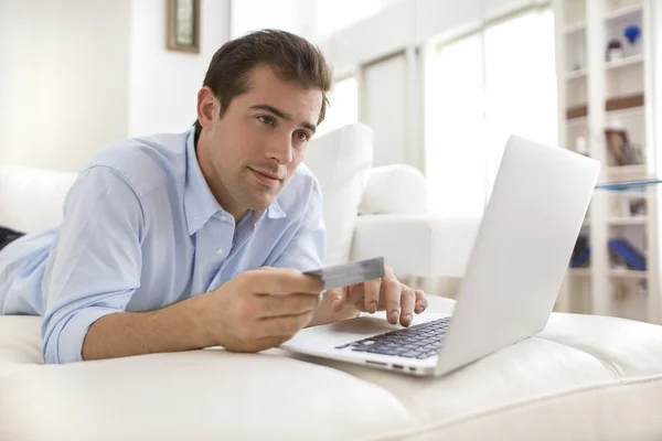 A man buys music online, at home — Stock Photo, Image