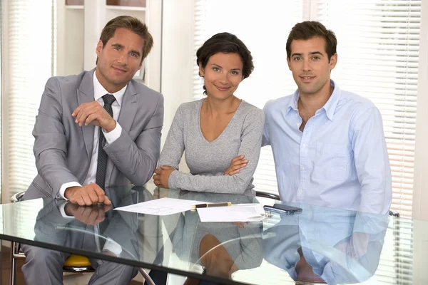 Feliz jovem casal assinar contrato financeiro, olhando câmera — Fotografia de Stock