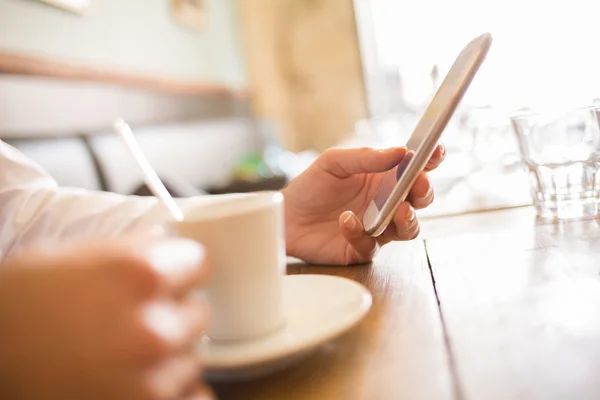 Close up of hands woman using her cell phone in restaurant — Stock Photo, Image