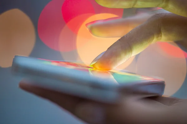 Mobile phone in a woman's hand, night lights — Stock Photo, Image