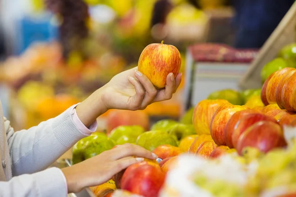 Жінка купує фрукти та овочі на ринку — стокове фото