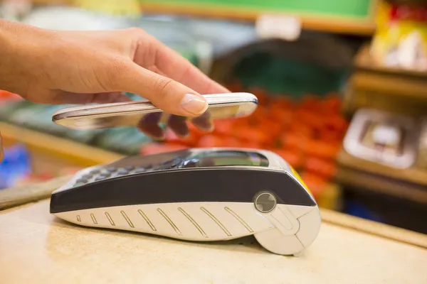 Mujer pagando con tecnología nfc en teléfono móvil, compras, supe — Foto de Stock