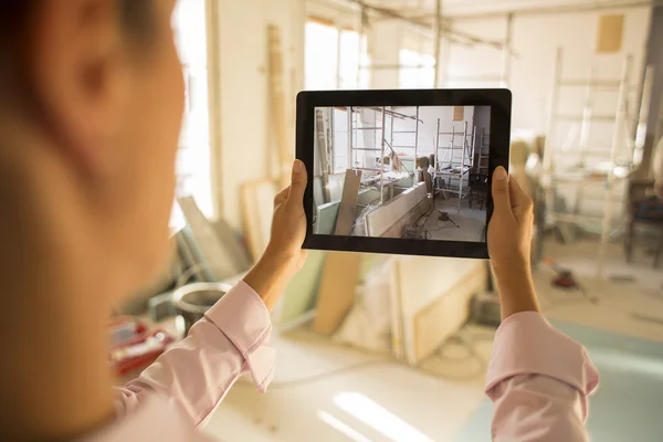 Architecte femme travaillant avec tablette électronique, prend une photo — Photo