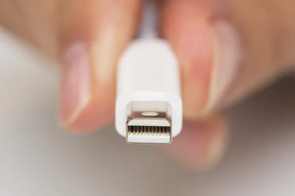 Man's hand holds a Thunderbolt Connector — Stock Photo, Image