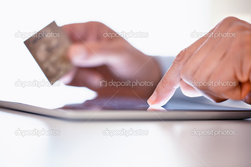 Man holding tablet pc and credit card indoor, Shopping online