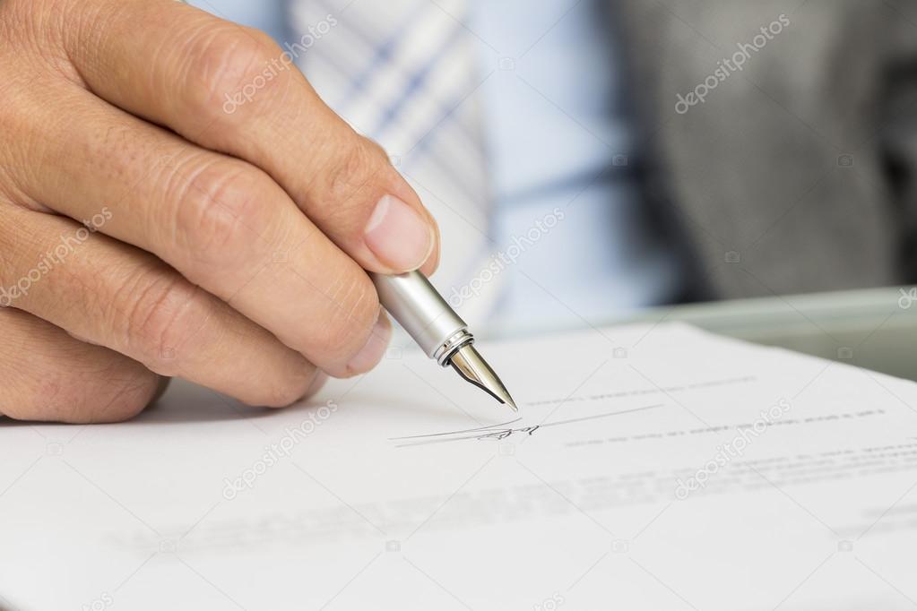 Businessman is Signing a Contract, focus on pen