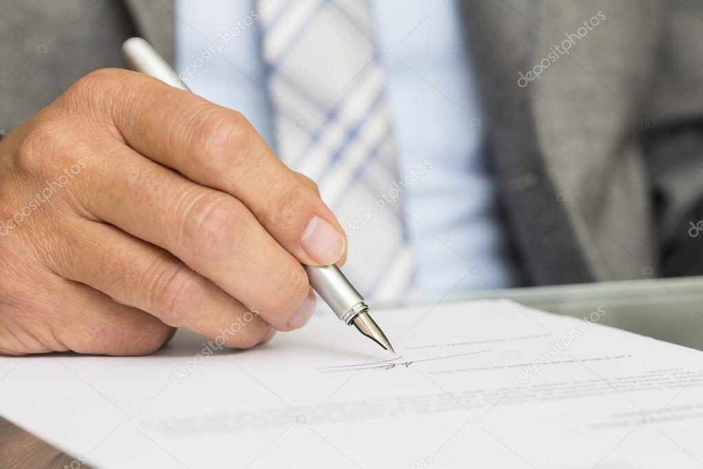 Businessman is Signing a Contract, focus on pen